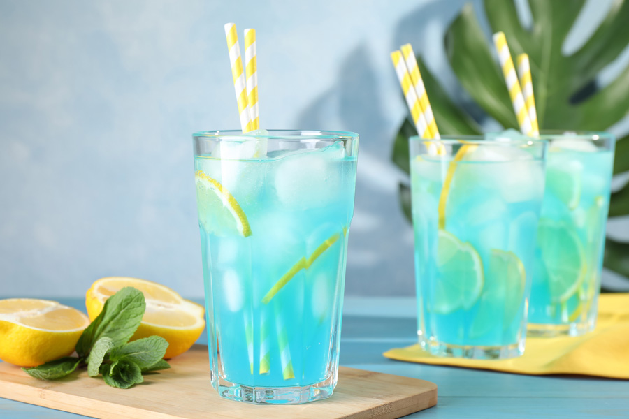 Opskrift Les Bleus Lemonade Stemningsbillede: Tre drikkeglas er fyldt med blå limonade.
